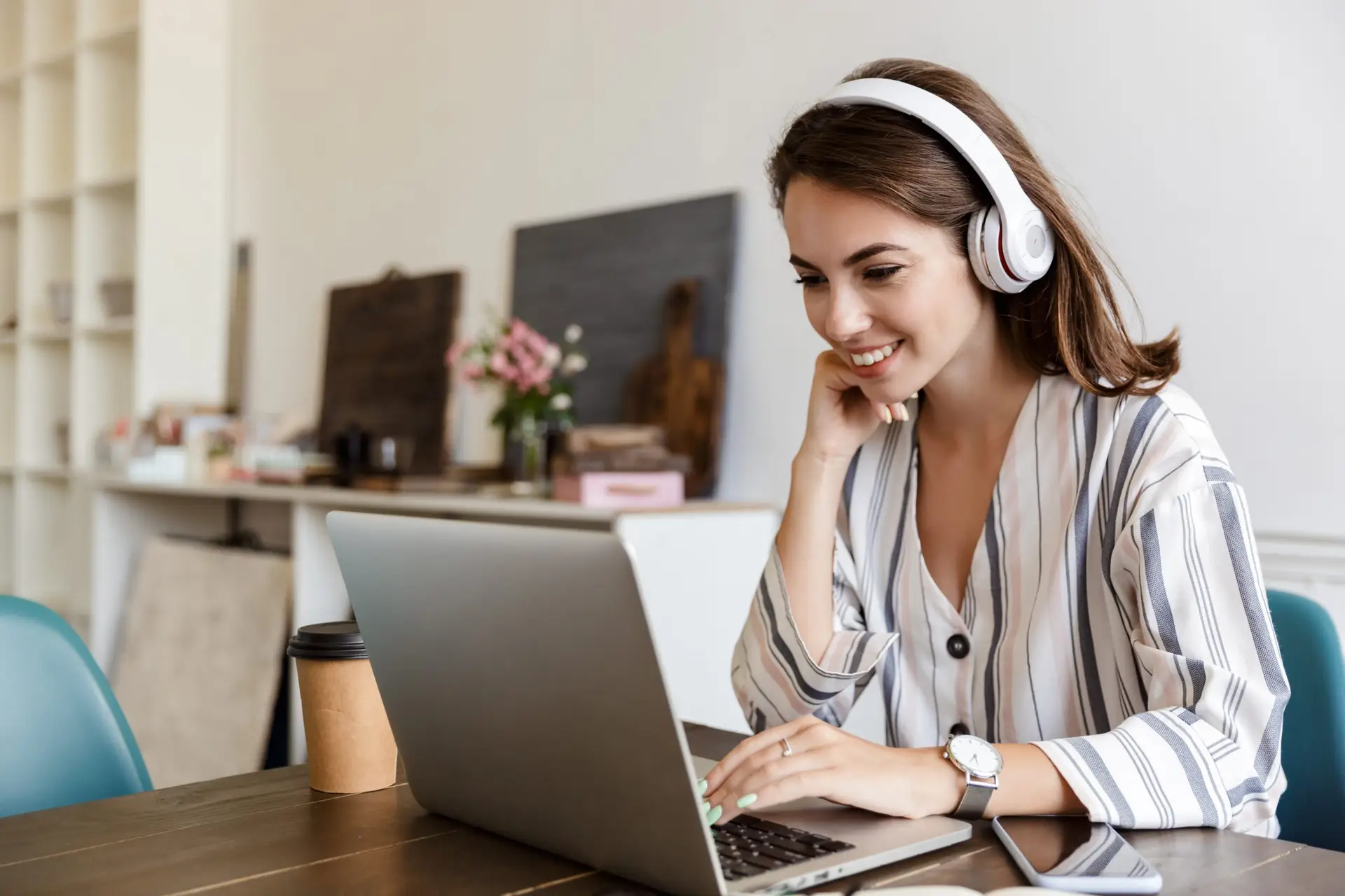 Smiling woman wearing headphones reviews high-quality transcription, symbolizing human accuracy and focus.
